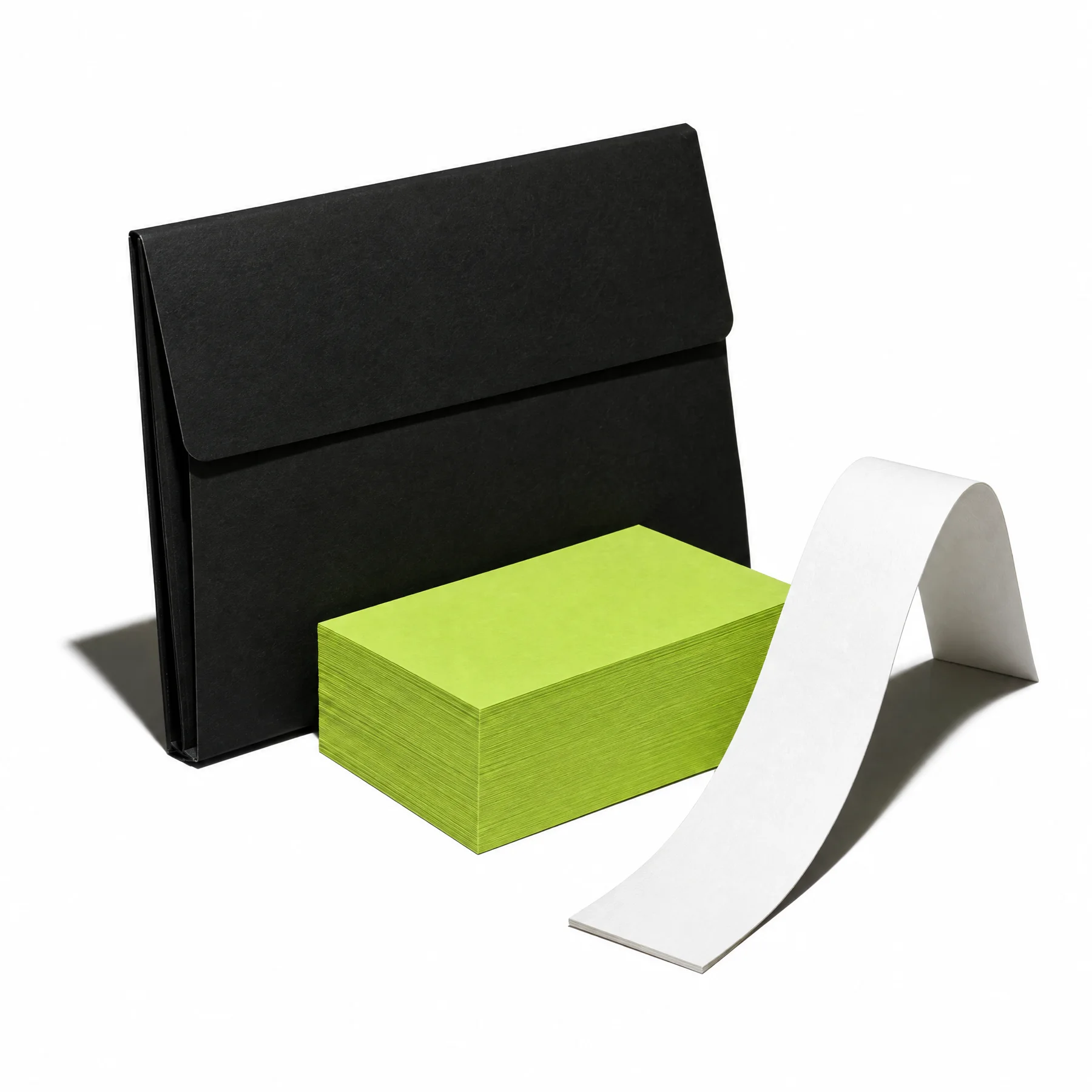 Black stationery case, lime cards, and a curling white paper strip